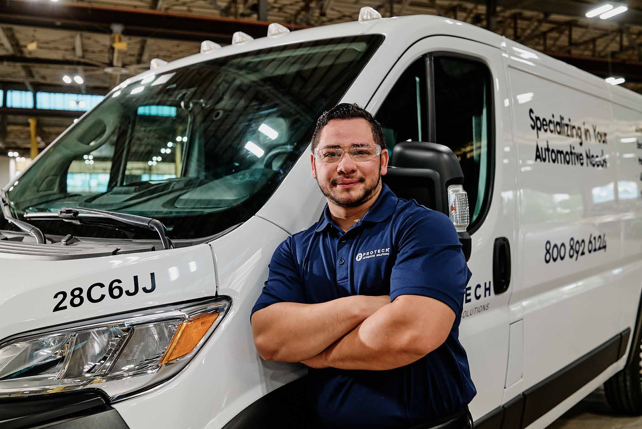 Protech technician standing beside a service van