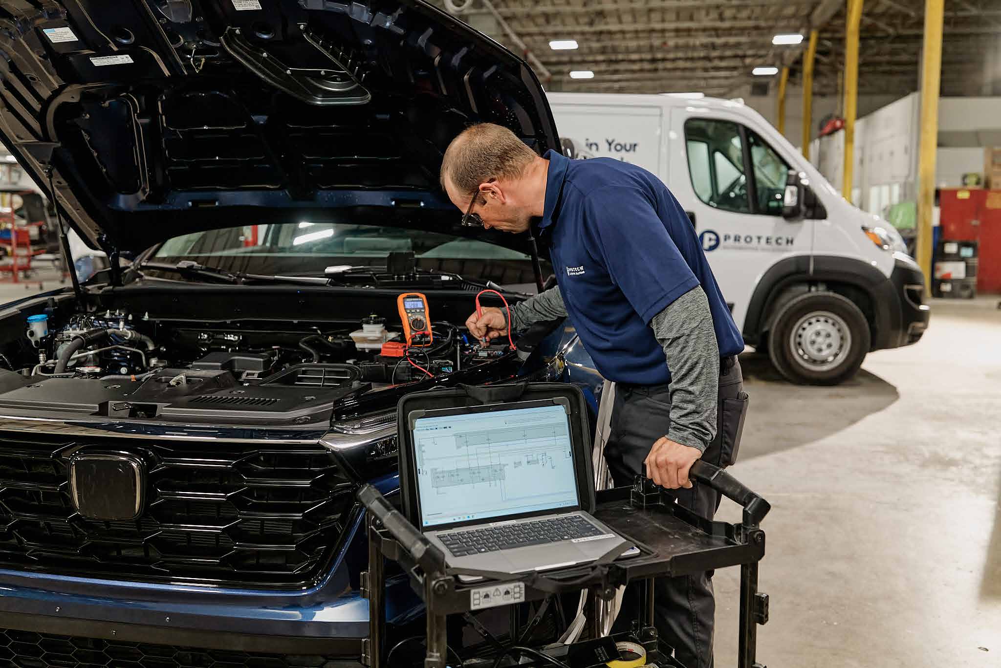 Protech technician scanning a vehicle in a shop